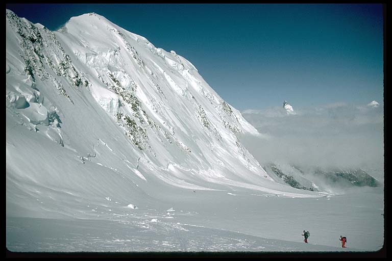 Skiers on the flanks of Monte Rosa looking towards the Matterhorn